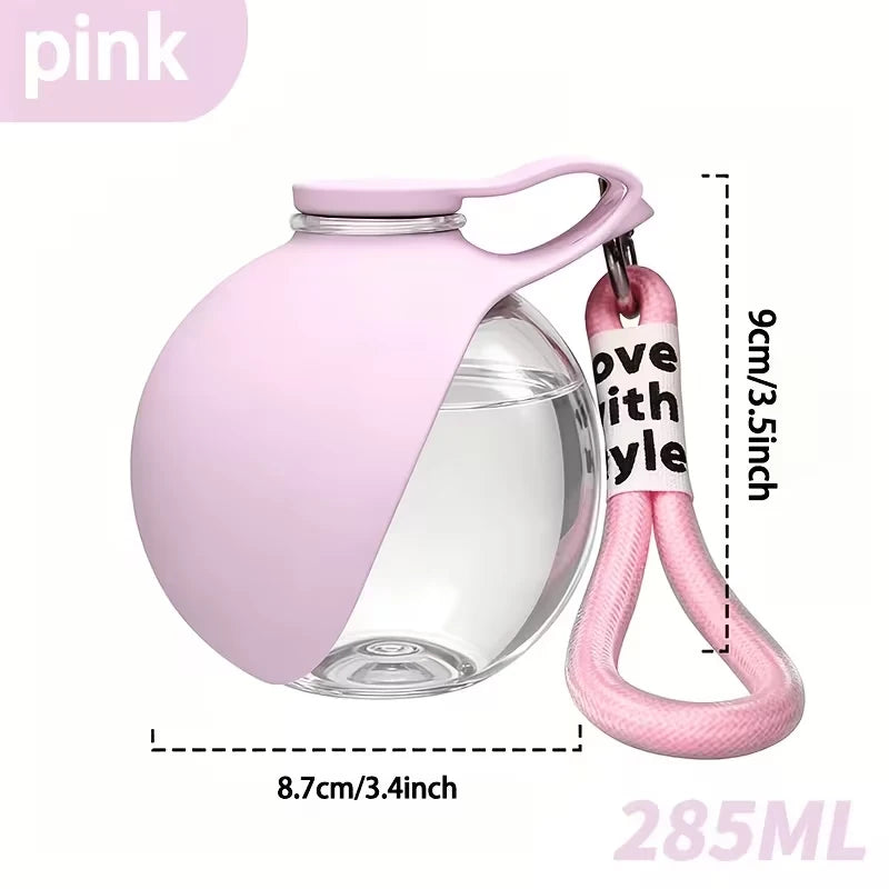 Portable spherical water bottle for pets; features a transparent, drop-resistant design with a lanyard; sealed and leak-proof.